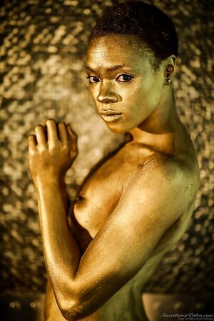 Painted in gold ebony Ana Foxxx looks stunning like a statue