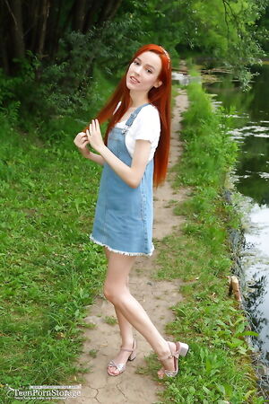  Skinny redhead girl loves to pose naked outside and show off her slim body