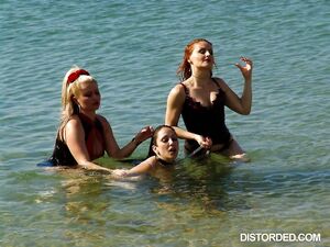 Female sub humiliated by her mistresses at the beach in messy femdom scene