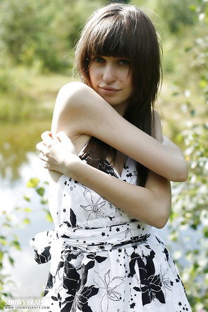 Teen Lena showing her boobs and her coochie besides a lake in beautiful forest