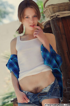 Teen with pigtails Bonnie Apricot in denim shorts flaunting her hairy pussy