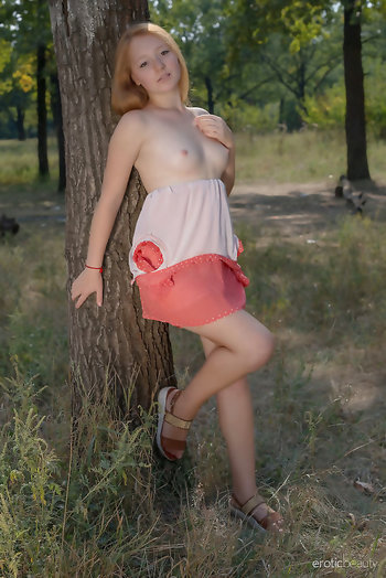 Small titty blonde Red Cat getting naked by the tree and shows her boobies