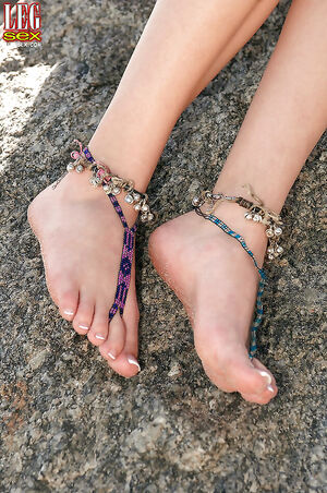 Lovely blonde Michelle Honeywell exposing her sandy feet at the beach