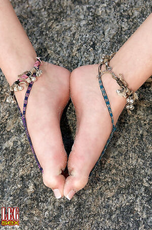 Lovely blonde Michelle Honeywell exposing her sandy feet at the beach