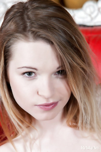 Beautiful blonde Malinda A on red chair showing off her perky tits and ass