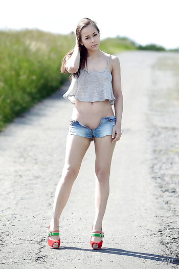 Solo girl in jeans stripping nude outdoors - On The Road Again