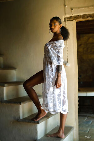 The ebony cutie takes off her white dress and reveals her deliciously toned body