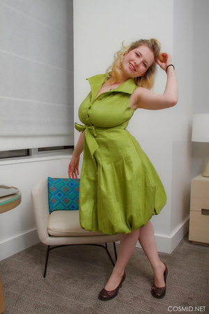 Mim Turner with natural big tits undresses green dress to pose naked on couch