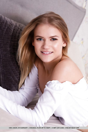 Skinny petite blonde Kira Angel strips off and shows her shaved pussy