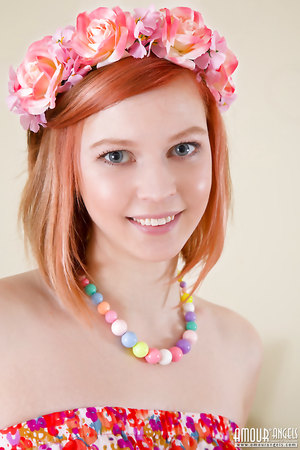 Cute redhead teen Izzy with flower crown and summer dress naked on table