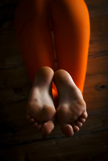 Marlyn A poses in orange pantyhose showing her sexy feet